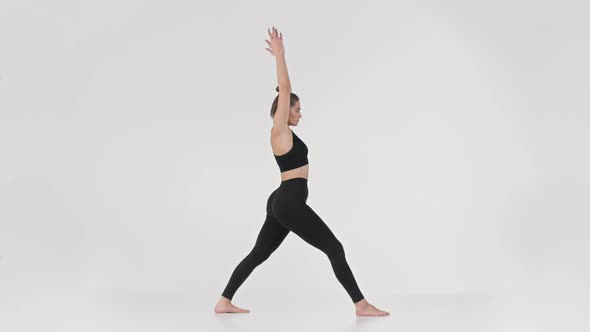 Full Length Portrait of Young Active Sporty Lady Practicing Warrior Position Doing Virabhadrasana alt