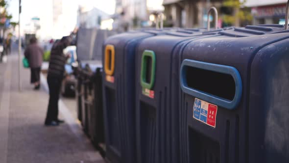 Man Disposing of Garbage in Waste Separating Bins alt