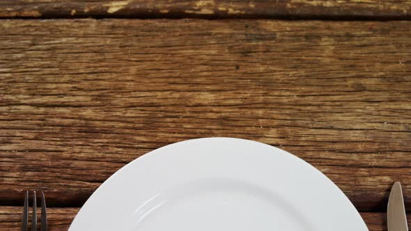 Various cutlery on wooden table 4k alt