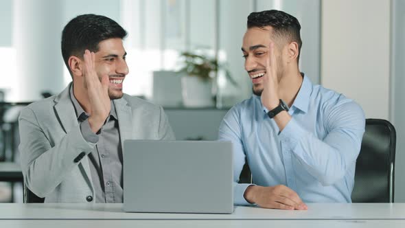 Two Arab Young Male Businessmen Sitting in Modern Office Satisfied with Result of Negotiations alt