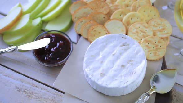 Brie cheese and cracker appetizer for  party table. alt