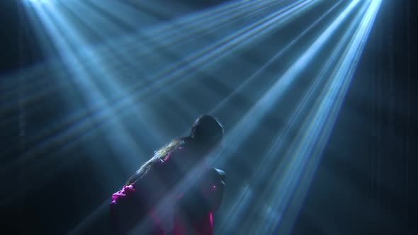 Silhouette a Young Girl Dancer in a Red Sari. Indian Folk Dance. Shot in a Dark Studio with Smoke alt