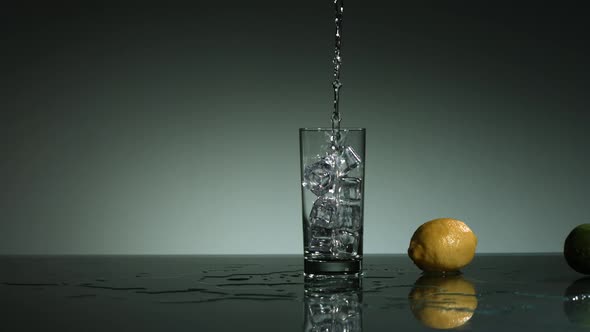 Carbonated liquid pouring into glass filled with ice - ultra slow mo 1500fps - LIQUID POUR  alt