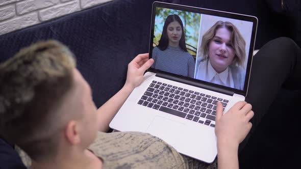 Young Man Talking By Video Chat Distance Studying Online Conference Students