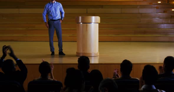 Male business executive giving a speech alt