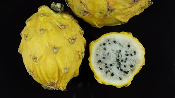 Pitahaya Yellow Exotic Fruit On Black Background.