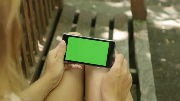 Working outdoor on green screen display mobile phone in female hands 4K 2160p 30fps UltraHD footage 