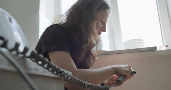 Woman Making Doll Ceramic Part. Female Sitting and Creating Ear for Doll at Home at Table. Pottery alt