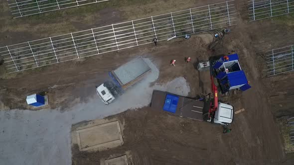 Top View of the Construction Work on a Solar Power Station Machinery and People alt