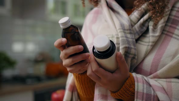 Woman holding bottles of remedy for her illness alt