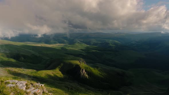 Low Clouds Over a Highland Plateau in the Rays of Sunset alt