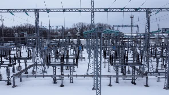 Aerial view of a high voltage electrical substation in winter season. alt