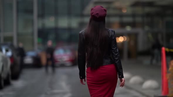 a Brunette with Long Hair in a Black Leather Jacket a Red Skirt and a Burgundy Cap Goes to a Modern alt