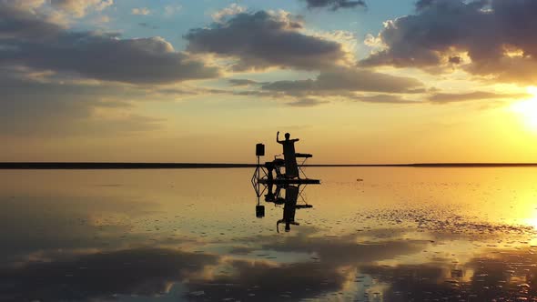 Young Lady in a Dress Is Standing on a Small Raft in the Sea and Dancing,  alt