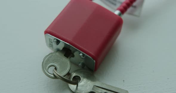 Close Up Tilt Up of a Red Gun Safety Lock alt