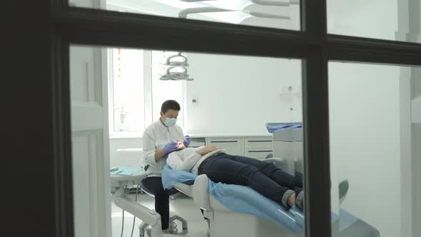 Dentist treating a patient alt