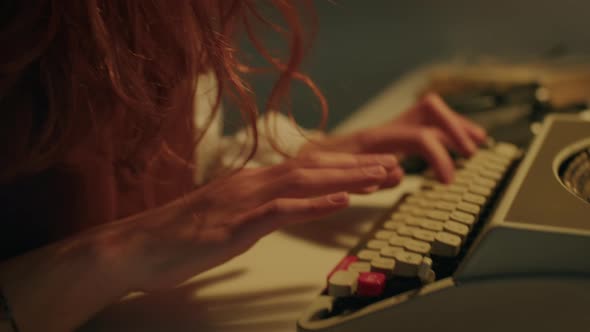 Sad and Disappointed Girl Writes on the Typewriter alt