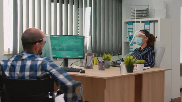 Disabled Worker Talking Wearing Protection Face Masks alt