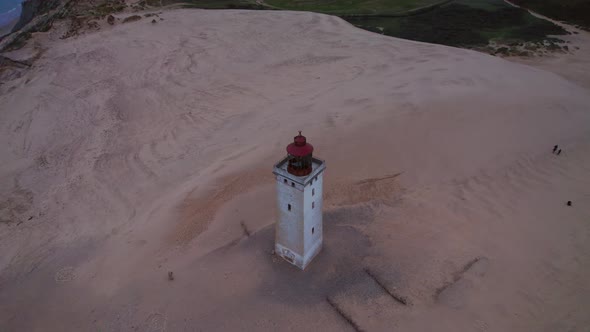 Drone Rising Over Rubjerg Knude Lighthouse On Beach alt