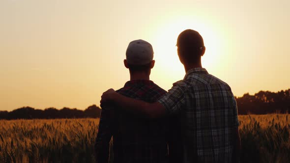 Two Men Gently Cuddle, Look Forward To the Boundless Field of Wheat alt