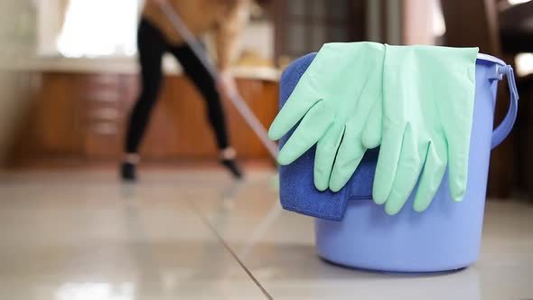 Close-up, home cleaning supplies. Girl dancing while cleaning the house alt