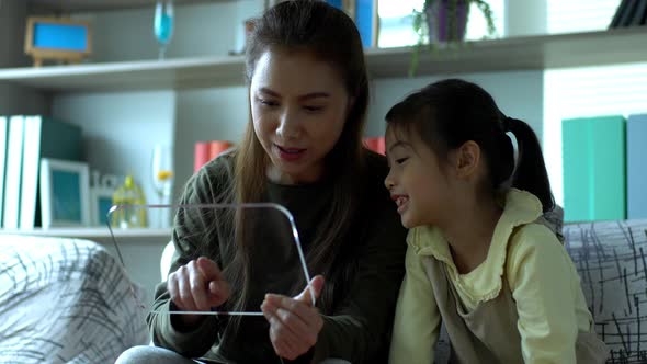 A futuristic virtual simulation of an Asian beautiful mother and a young daughter enjoy playing with alt