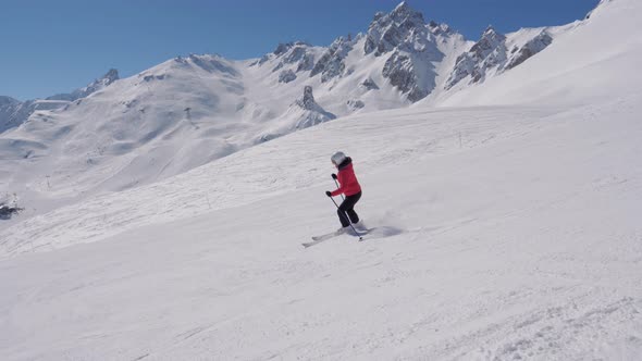 Bright Skier Slides Down Snowy Slope In Mountains In Winter On Skis alt