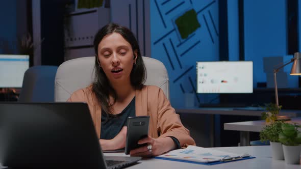 Overworked Businesswoman with Headphones Discussing Marketing Strategy alt