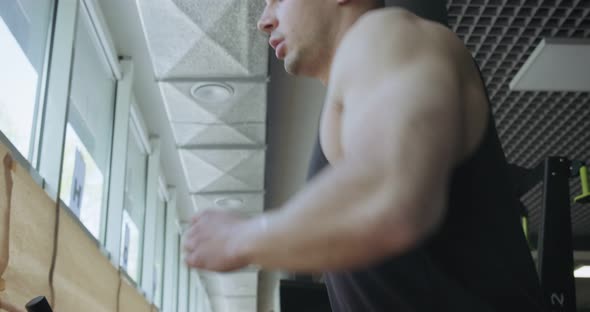 Man Running on Treadmill in Gym. Men Doing Difficult Cardio Workout with Air Runner alt