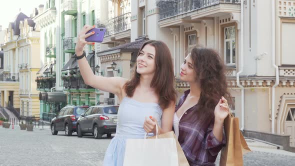 Lovely Female Friends Taking Selfies on Smart Phone After Shopping