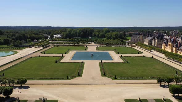 Aerial View of Medieval Landmark Royal Hunting Castle Fontainbleau and Lake with White Swans, France