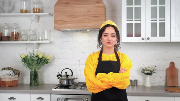 Portrait Serious Housewife Crossing Hands Looking Camera in Home Modern Kitchen alt