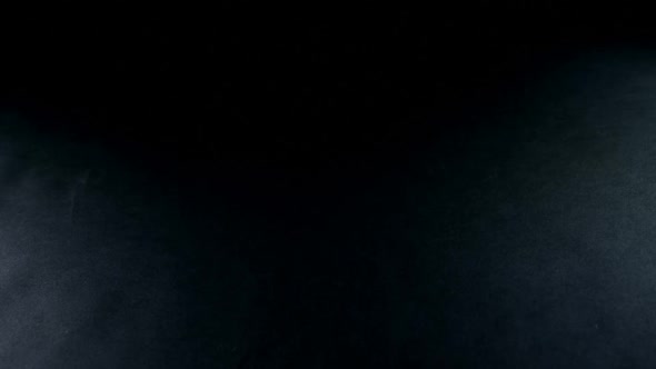 American football jersey fabric falling on black background 4k alt