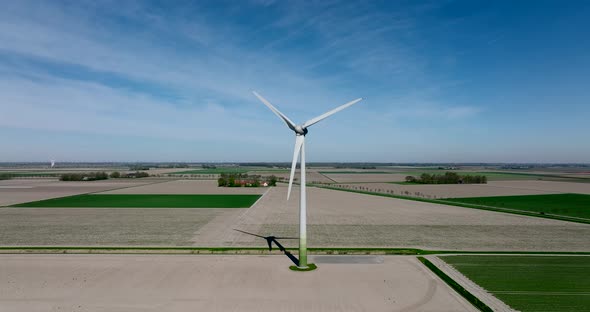 Wind turbines generating electricity in a flat Dutch landscape. alt