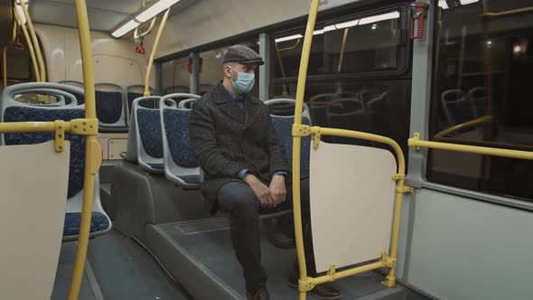Young Man Wearing Face Mask Travelling in the Bus alt