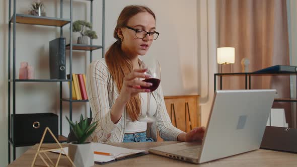 Focused Woman Freelancer Drinking Wine While Working Typing Online on Laptop at Home Distance Office alt