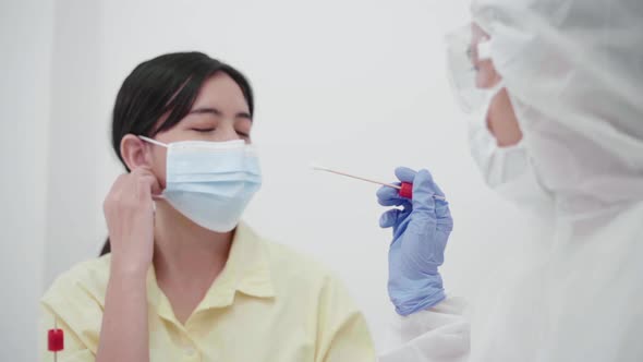 Medical personnel in the protective suit taking  swab or PCR  for corona virus test.