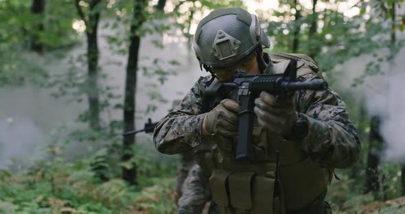 Soldiers Taking Aim From Rifle in Forest Smoke in Background Military and Army Concept alt