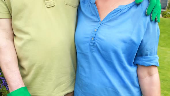 Senior couple standing in backyard alt