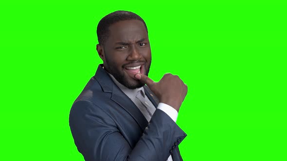 Young Sexy Dark-skinned Businessman Touching His Lips. alt