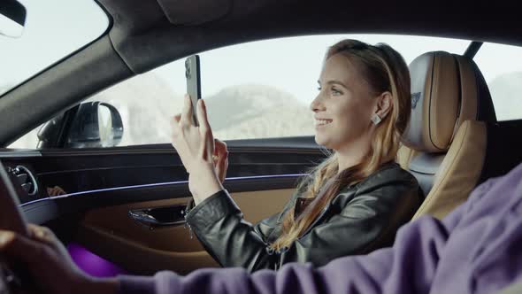 A passenger takes photos of the road while the car is moving.