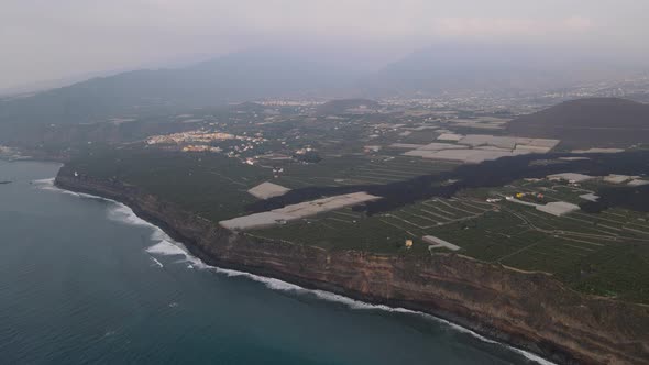 Banana plantation fields destroyed by solidified lava, La Palma island. Aerial drone view alt
