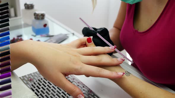 Manicurist Working on Client Nails