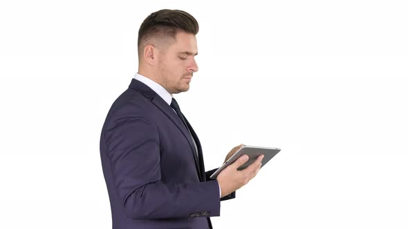 Young Businessman Touching Digital Tablet and Checking Object Infront of Him on White Background. alt