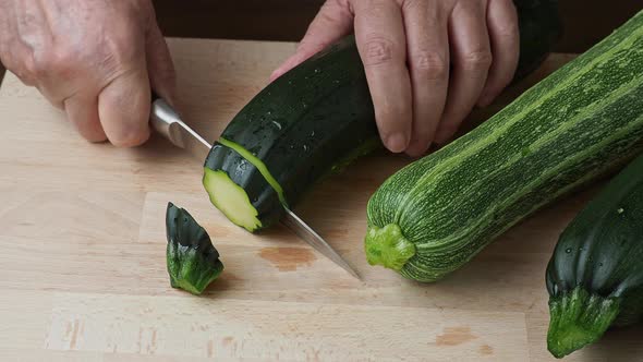 Slicing zucchini. Fresh zucchini on cutting board