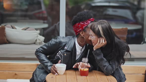 Flirty Black Woman Chatting to Girlfriend Outside Cafe alt