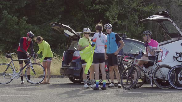 Group of cyclists taking break and preparing for ride.  Fully released for commercial use.