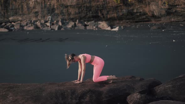 Side View of Sexy Girl in Tight Sportswear Stretch Her Legs and Glutes alt