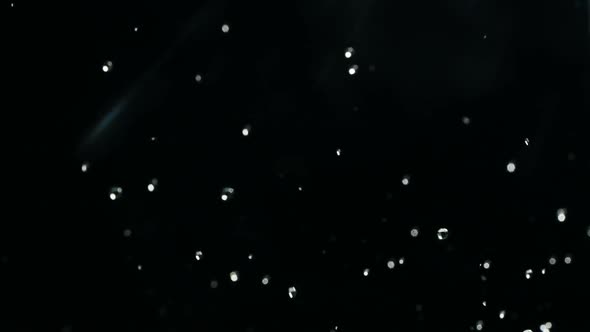 Rising and Falling Drops Footage in Slow Motion on Black Background. Falling Boiling Water Droplets alt