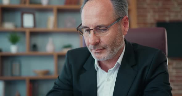 Handsome Attantive Hardworking 50s Bearded Head of Company Typing on Computer Keyboard alt